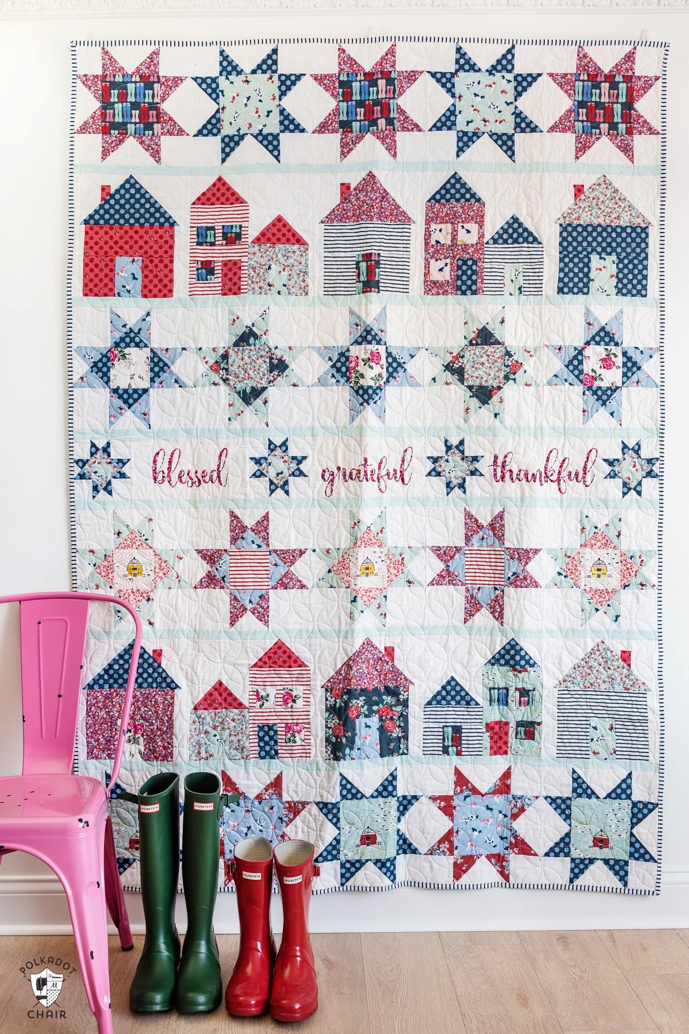 red white and blue quilt with stars and house blocks