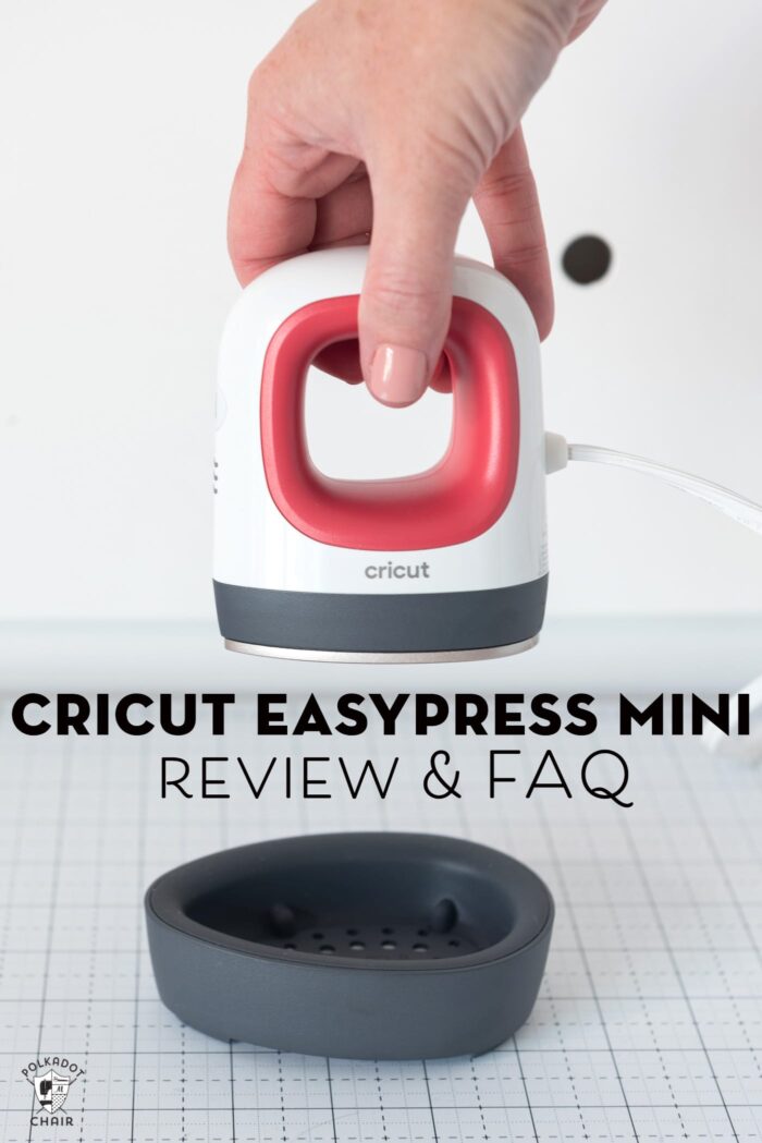 Hand holding a Cricut EasyPress mini iron.