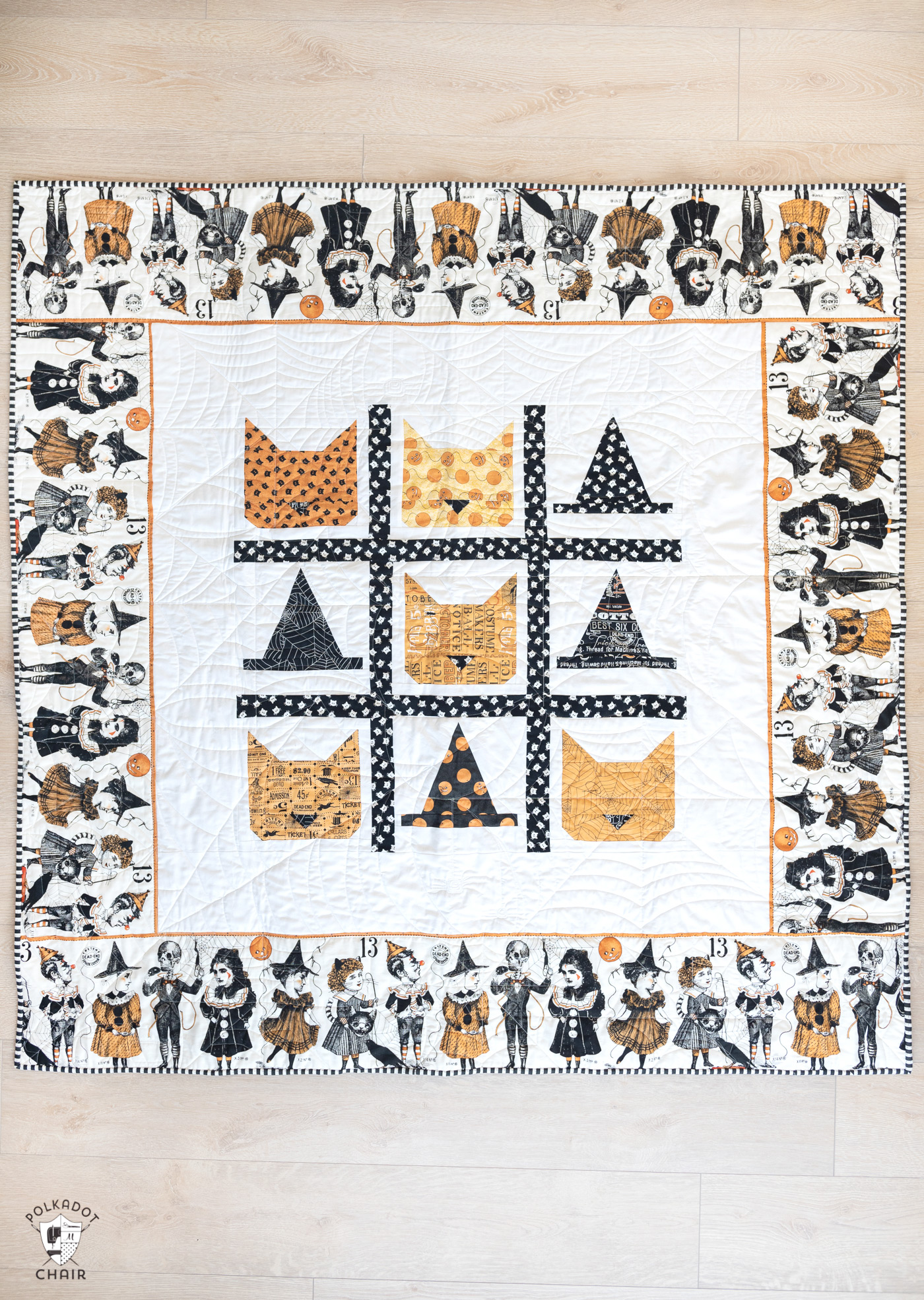 cat and witch hat quilt on floor