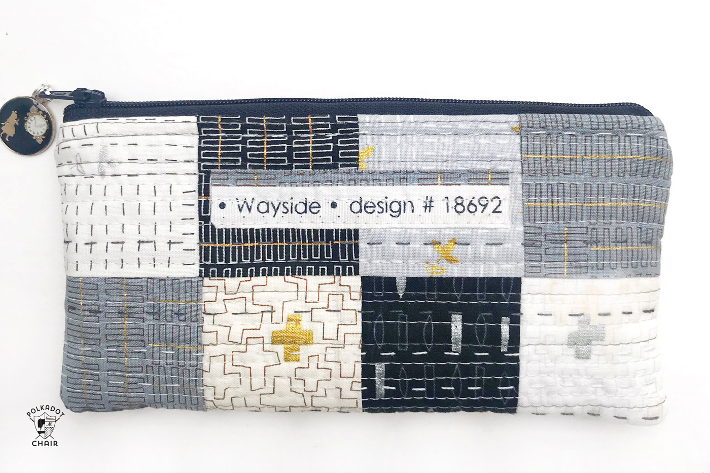 Simple quilted patchwork pencil case on white table