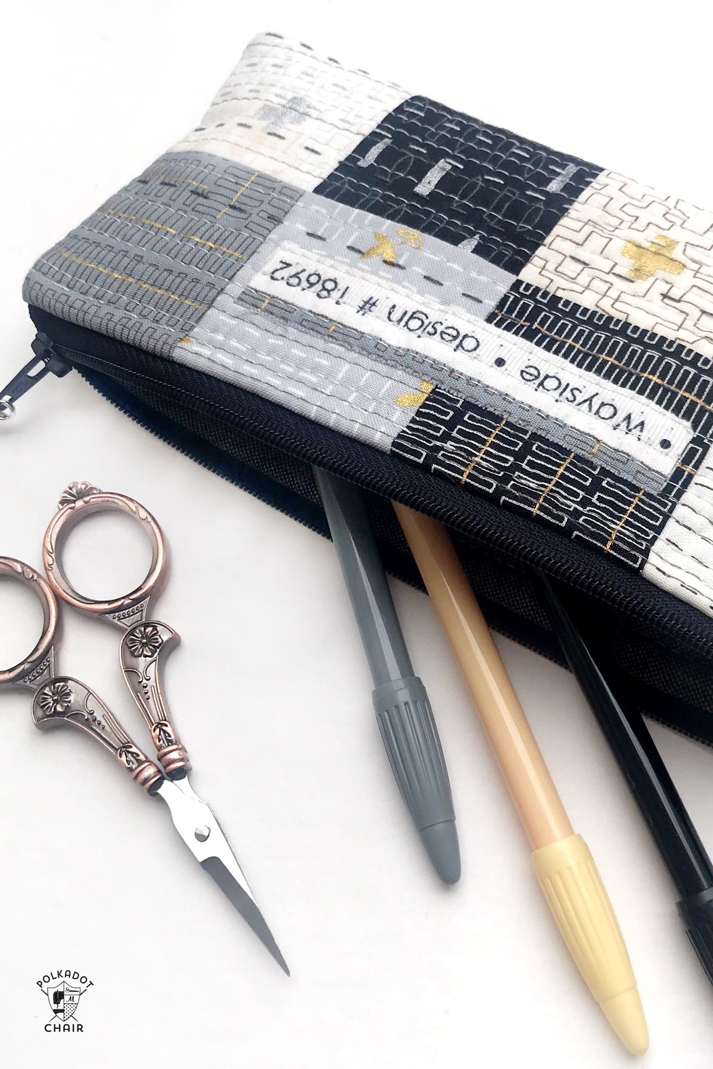 DIY pencil bag with pens and scissors coming out of it on a table