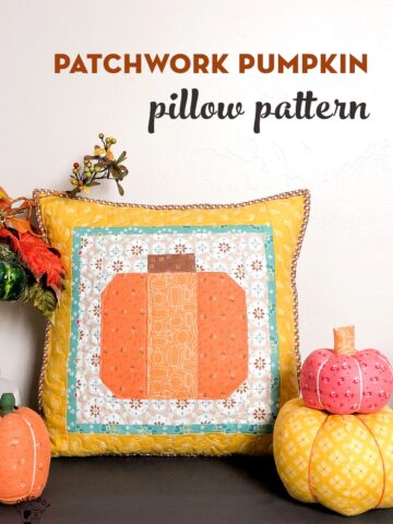 Patchwork Pumpkin Pillow on table decorated for Fall with fabric pumpkins