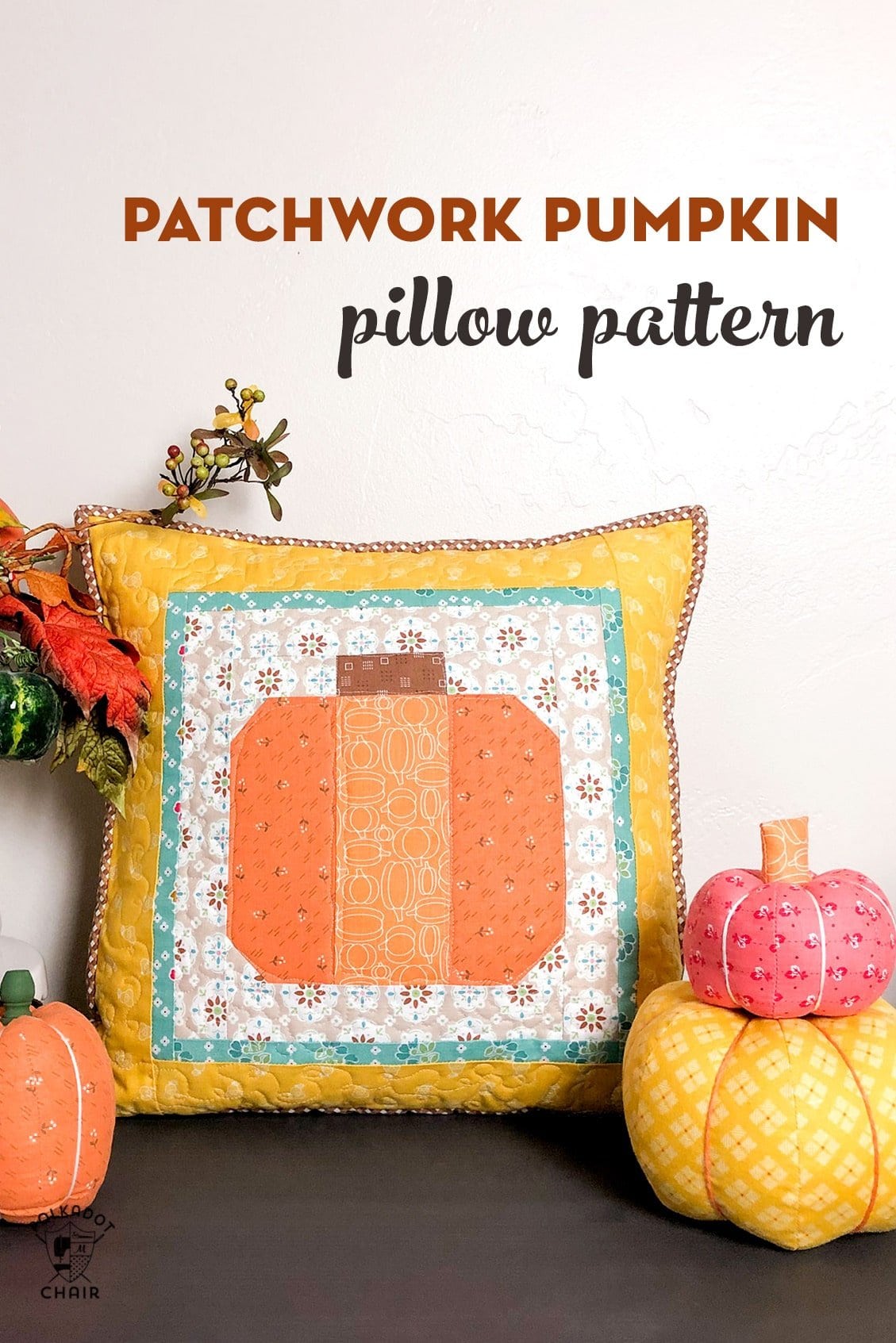 Patchwork Pumpkin Pillow on table decorated for Fall with fabric pumpkins