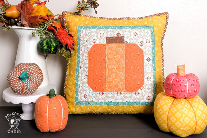 Patchwork Pumpkin Pillow on table decorated for Fall with fabric pumpkins