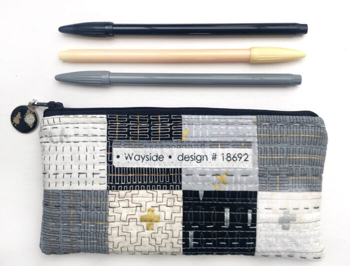 Simple quilted patchwork pencil case on white table