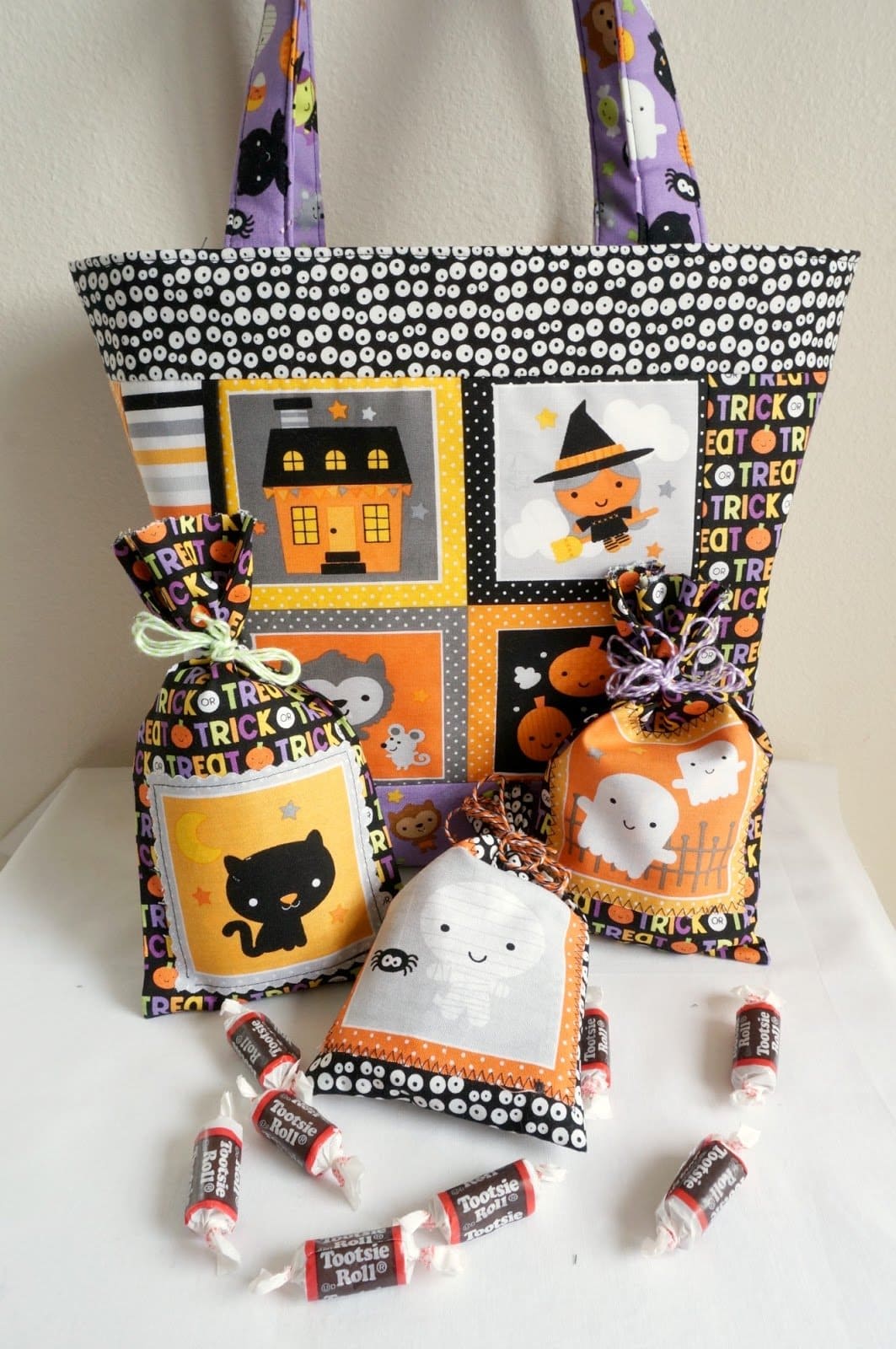 Colorful Halloween themed trick or treat bag on table with treats