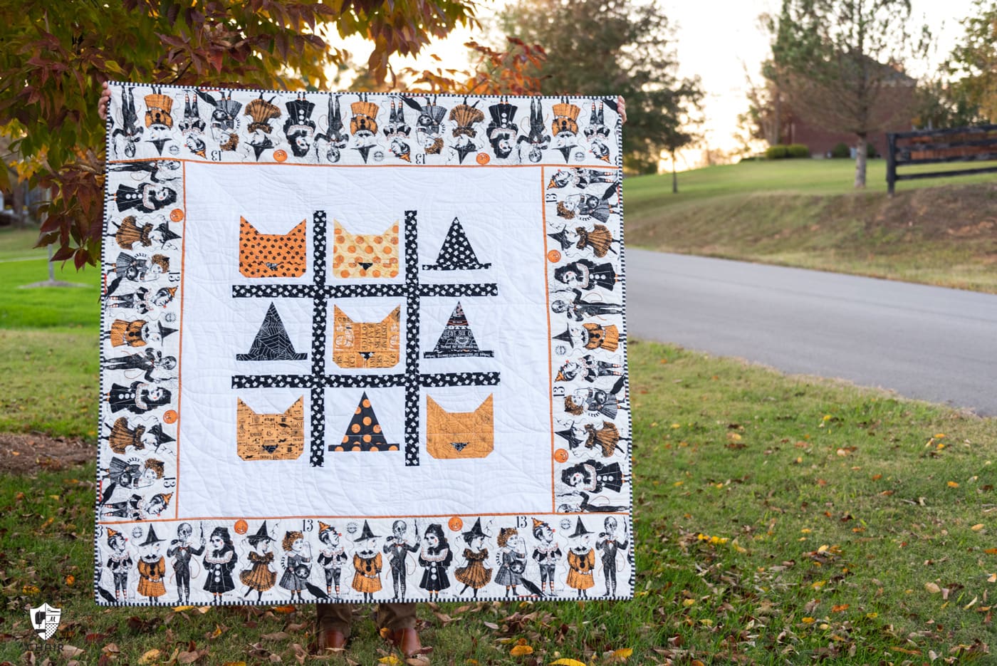 Halloween quilt made from cat and witch hat blocks outdoors