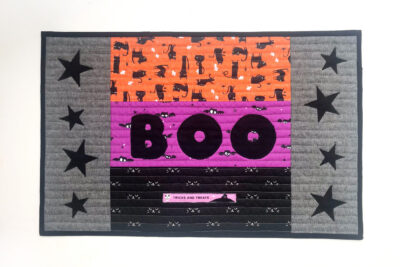 quilted halloween placemat on table with halloween decorations