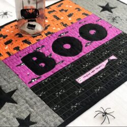 quilted halloween placemat on table with halloween decorations