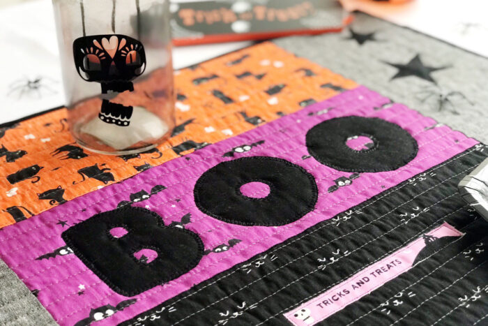 quilted halloween placemat on table with halloween decorations