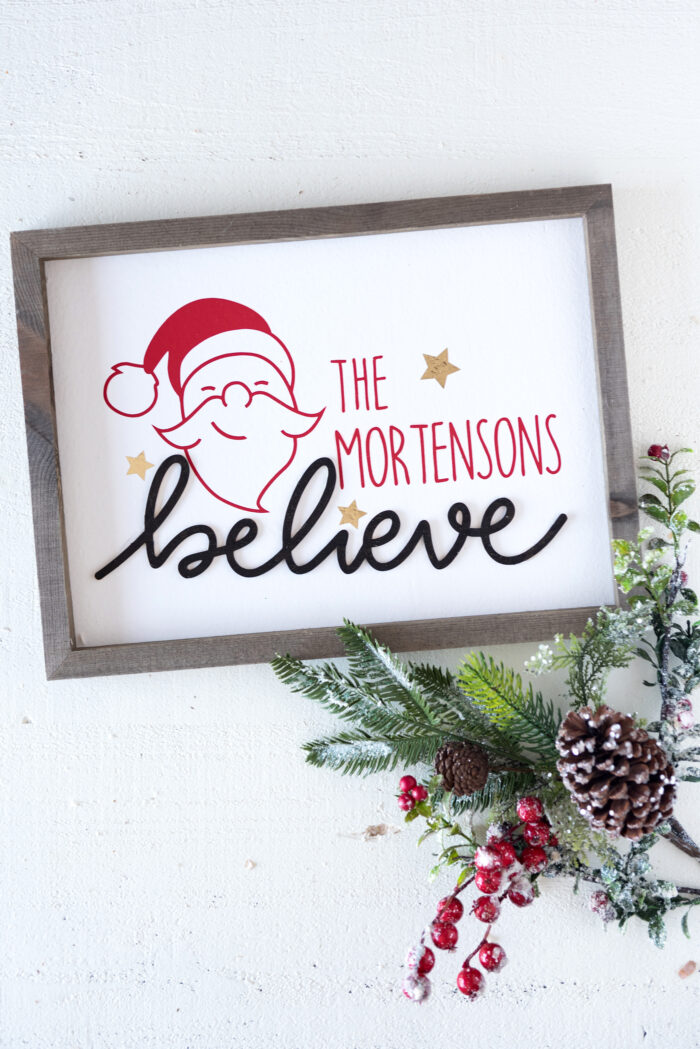 Believe Wood Christmas Sign on white table
