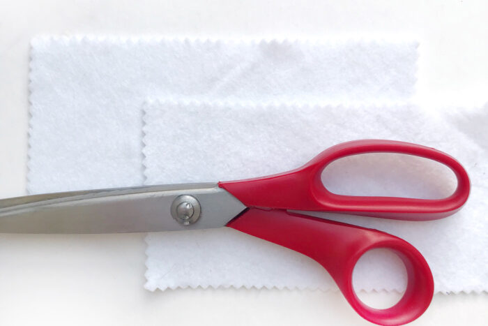 pinking shears and white felt on white table