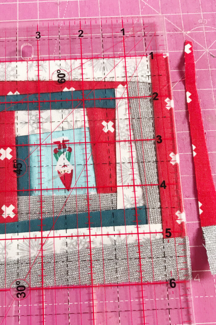 squaring up improv quilt block on pink cutting mat