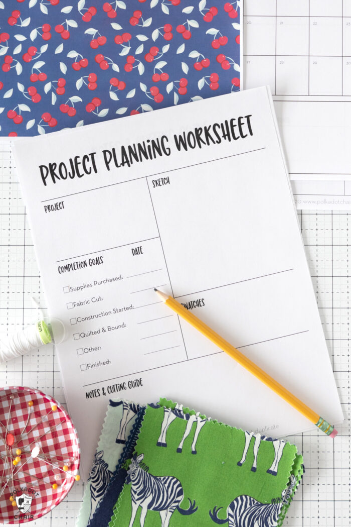 printed out planner pages on white grid cutting mat