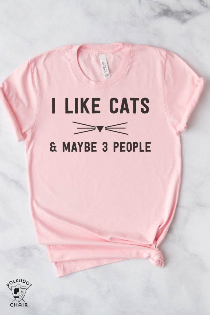 i like cats and maybe 3 people pink tshirt on white table