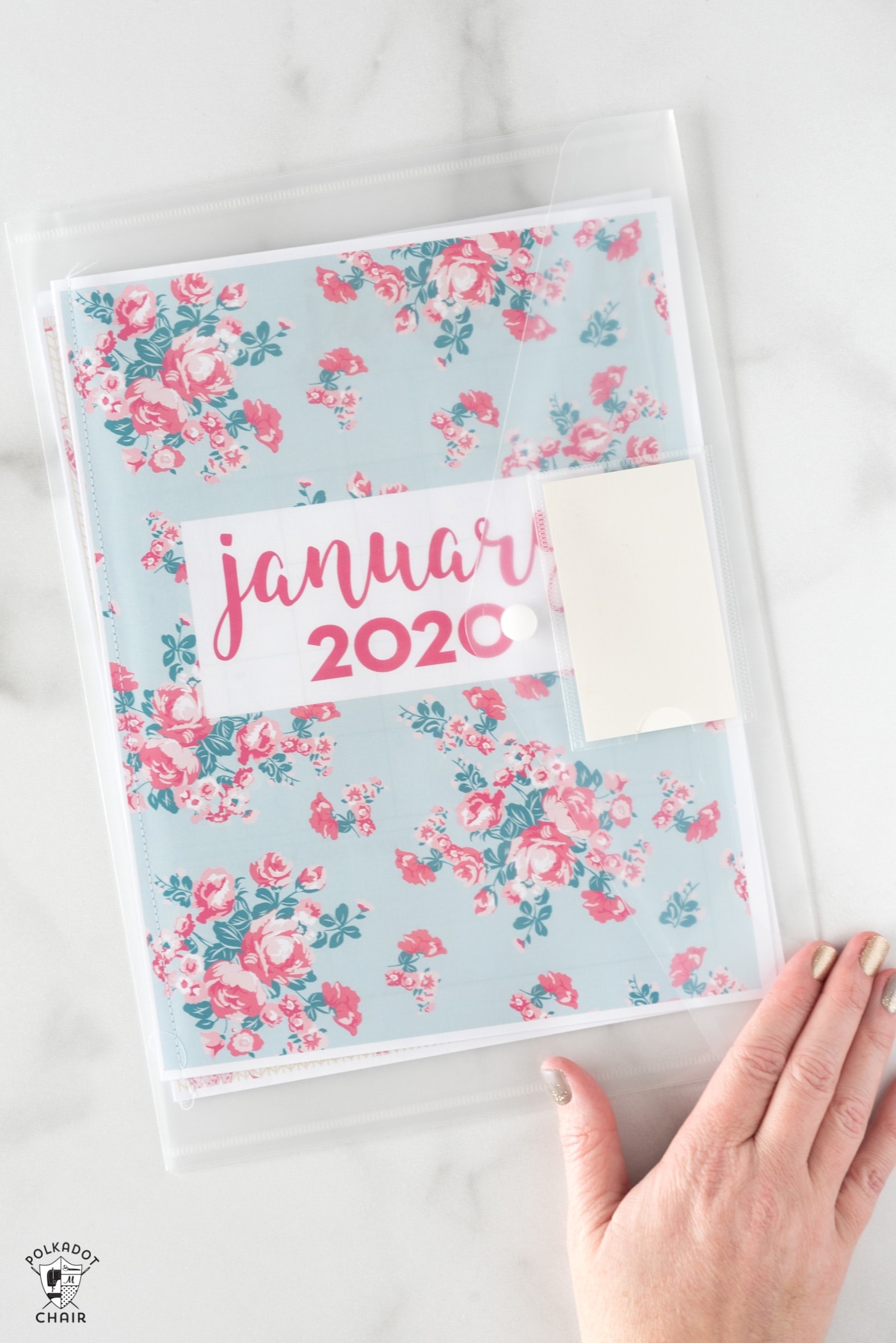planner pages in clear envelope on white table