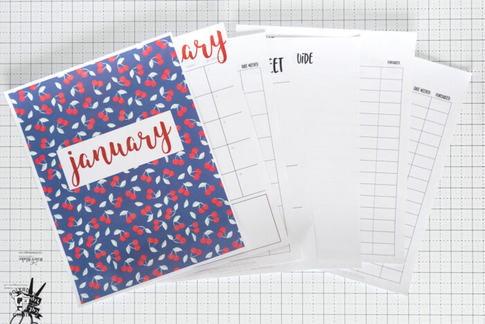 printed out planner pages on white grid cutting mat