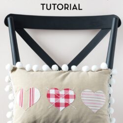 Heart Valentine Pillow on black chair in front of pink wall