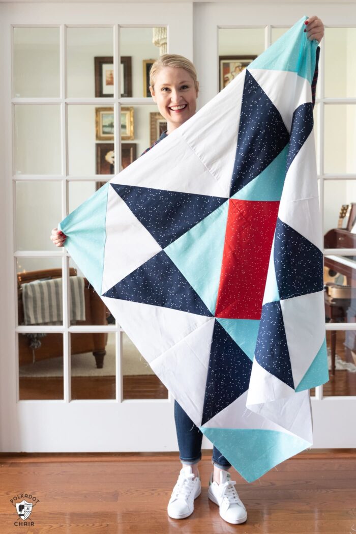 woman holding red white and blue baby quilt