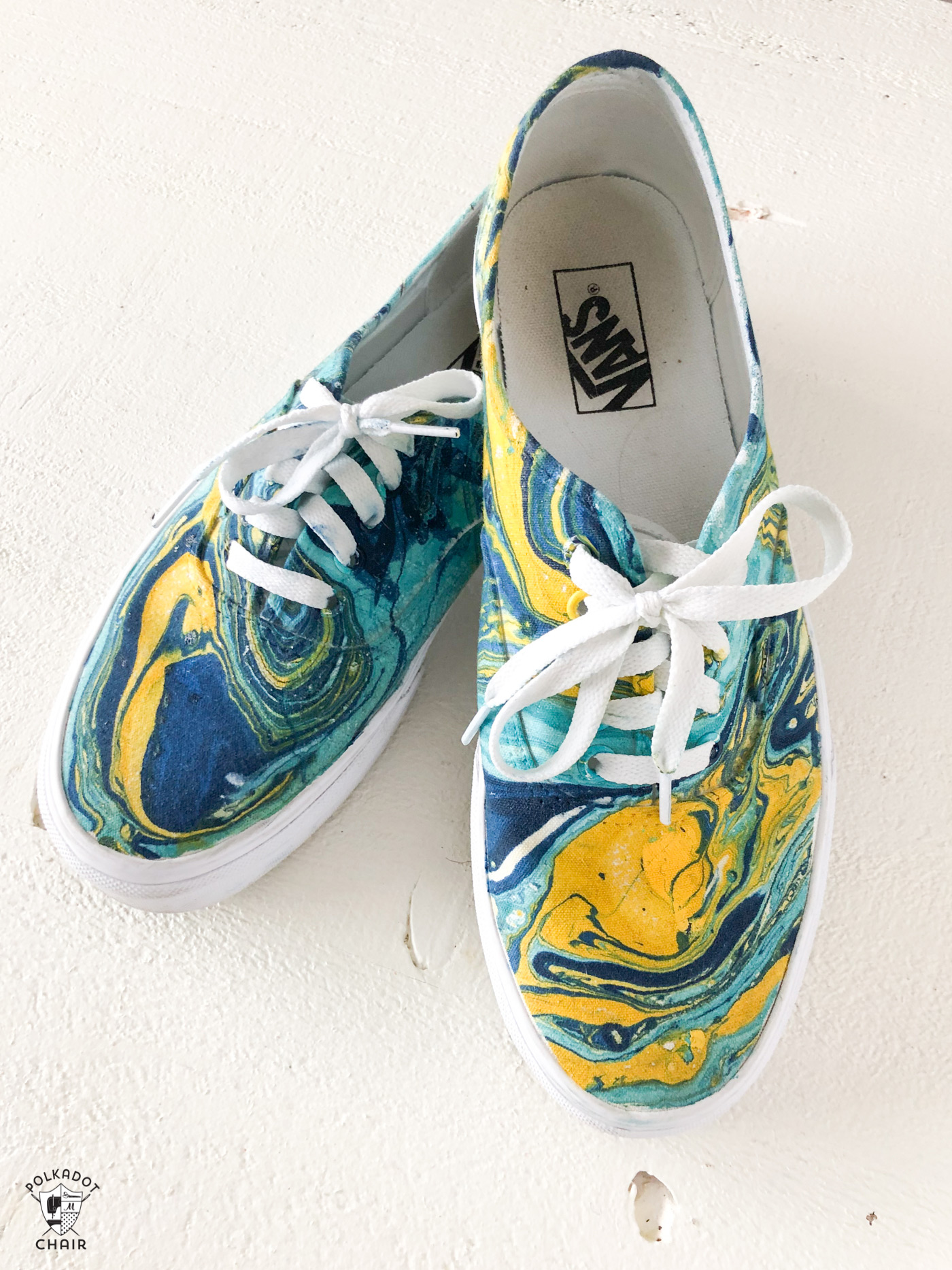 blue, yellow and aqua hydro dipped vans on white table