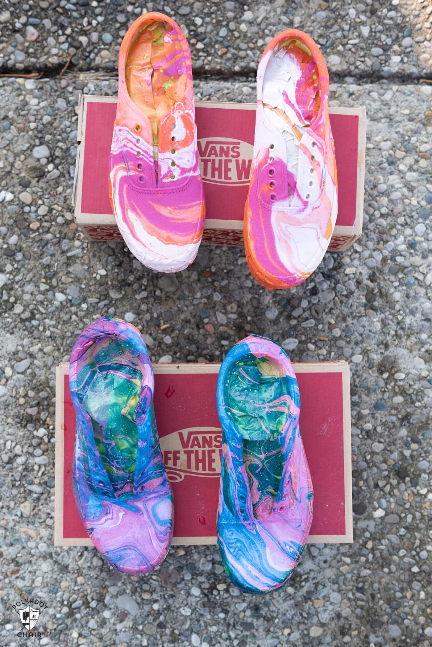 White orange and pink, and blue and pink  hydro dipped vans drying in the sun on a shoe box after being dipped.