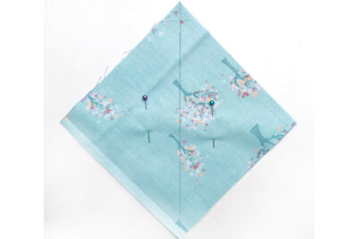 Blue square of fabric on white table