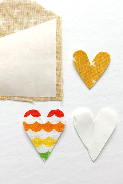heart appliques in various states of construction on white table