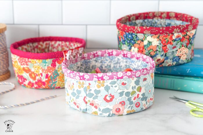 round fabric baskets on white countertop with books