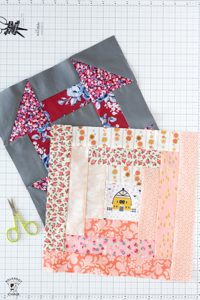 log cabin and churn dash quilt block on white cutting mat