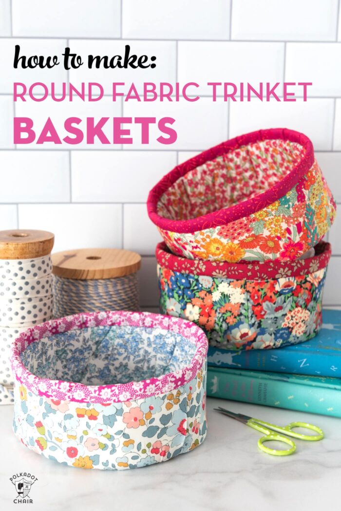 Round fabric baskets on stacked on books with white background