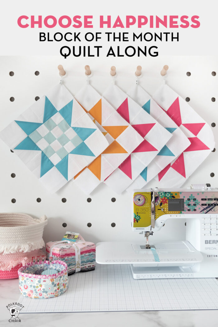 quilt blocks pinned to peg board with sewing machine on table