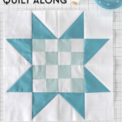blue and white quilt block pieced on white cutting mat