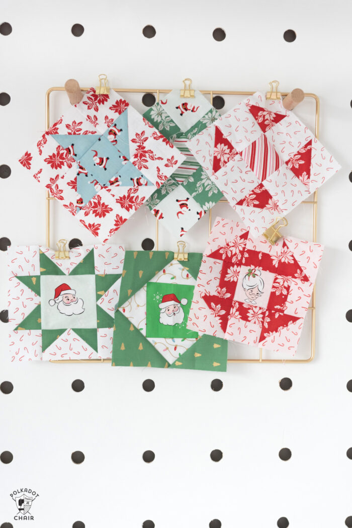 quilt blocks pinned to peg board with sewing machine on table