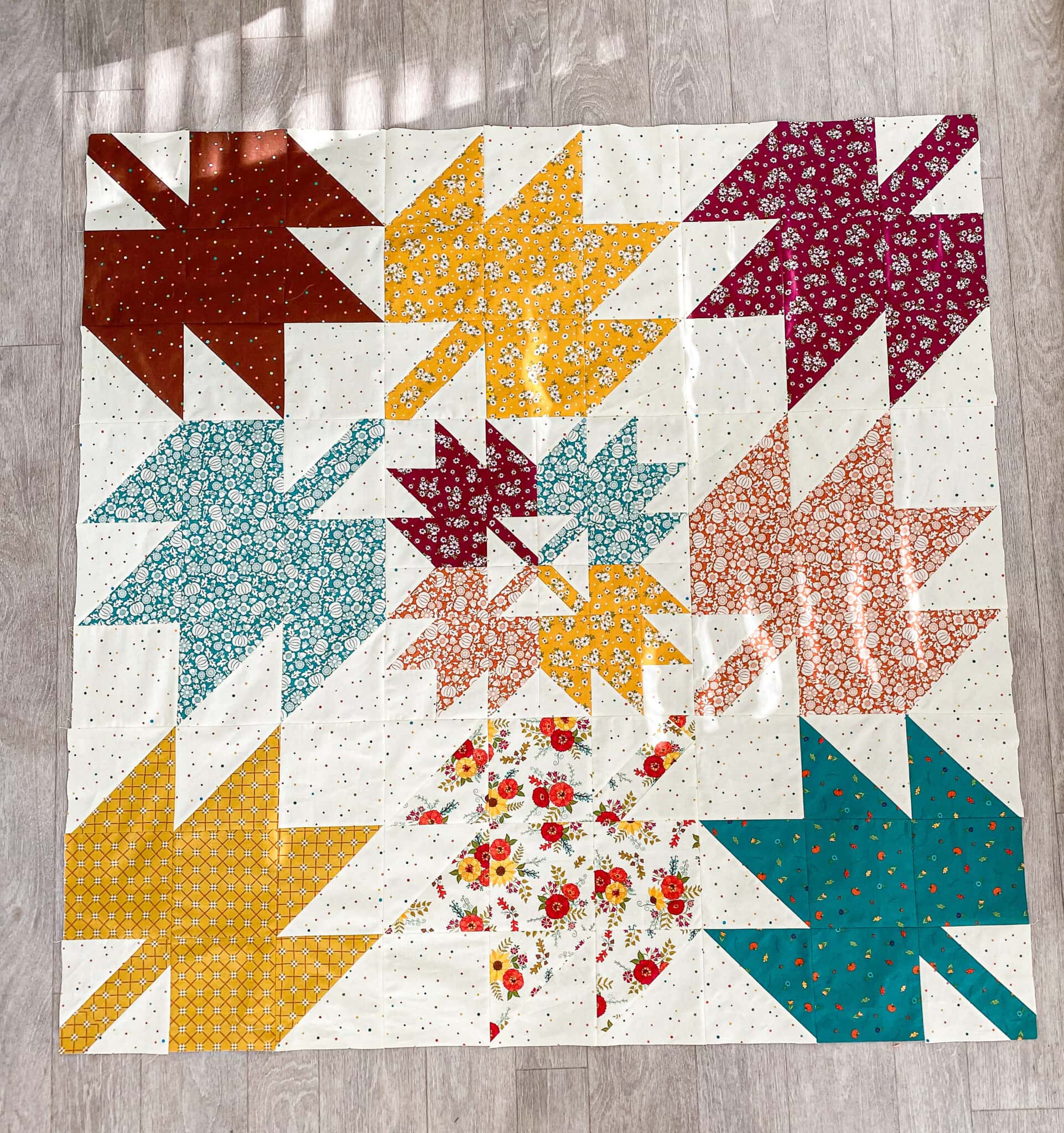 Autumn leaf quilt on floor