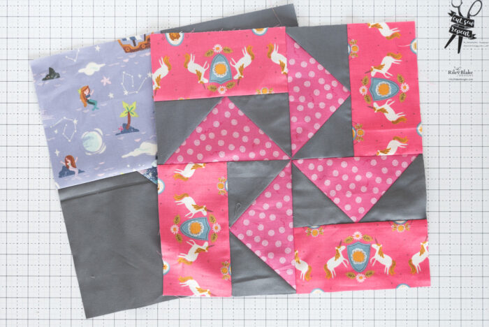gray pinwheel quilt block on white cutting mat