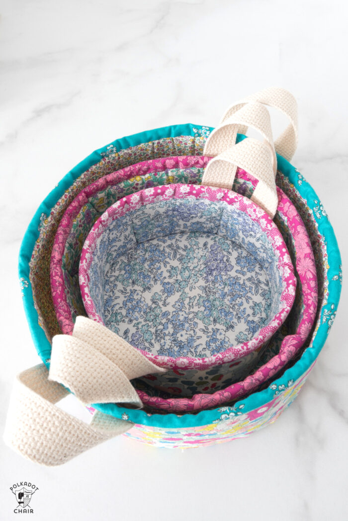 nesting fabric baskets on white marble table