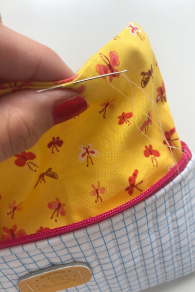 hand with needle stitching pencil pouch