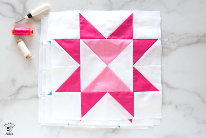 summer sunsets pink quilt block on white marble table with pink cutting mat