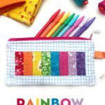 rainbow pencil pouch on white table with spools of thread and fabric