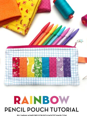rainbow pencil pouch on white table with spools of thread and fabric