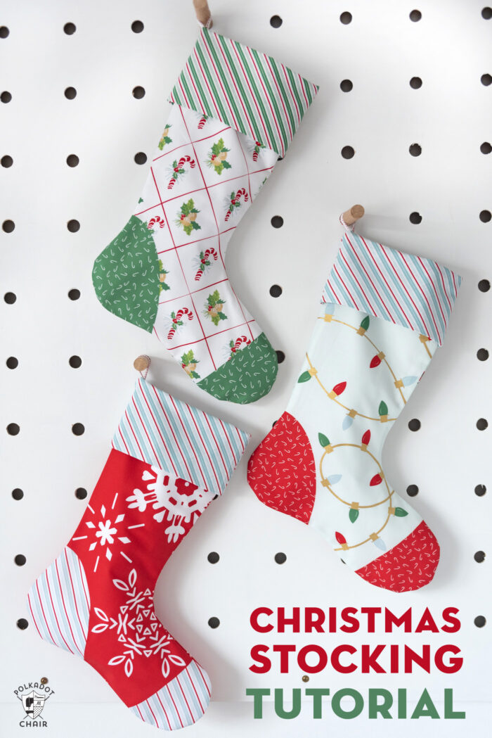 Red, blue and aqua christmas stockings on white peg board