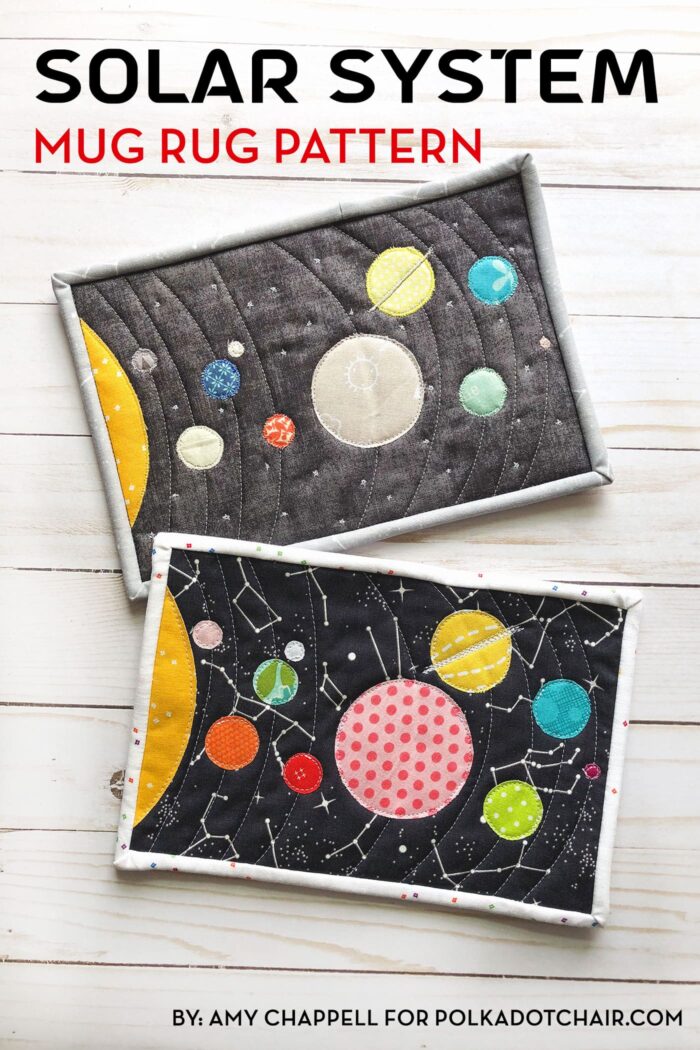 Colorful fabric Solar System mug rug on white wood table