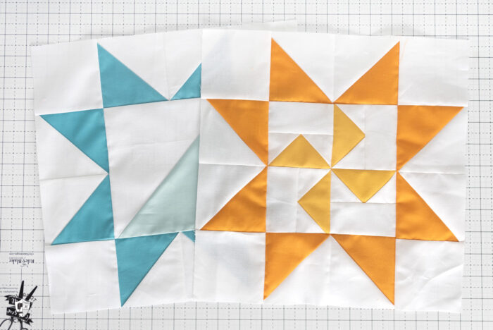 blue quilt block and yellow quilt block on white cutting mat