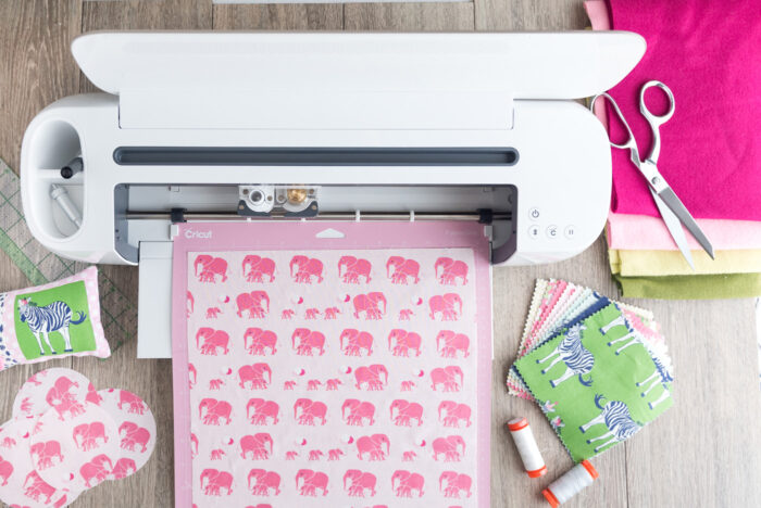 cricut machine on wood table with fabric