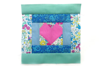 heart quilt block on white table