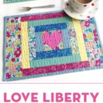 quilted placemat made from liberty fabrics on white table with polka dot tea cup