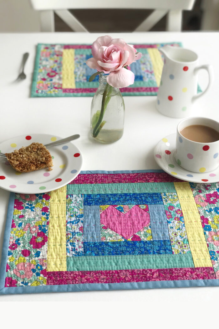 quilted placemat made from liberty fabrics on white table with polka dot tea cup