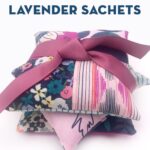 stack of lavender sachets tied up with ribbon on white table