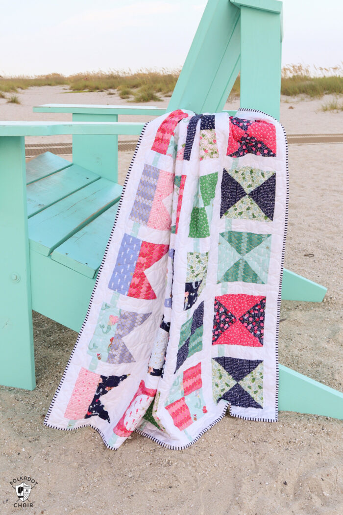 seas the day nautical quilt on giant blue beach chair on beach