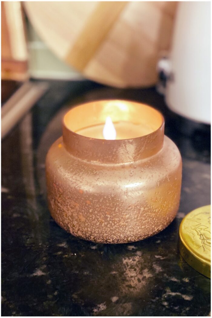 photo of orange candle on black granite countertop